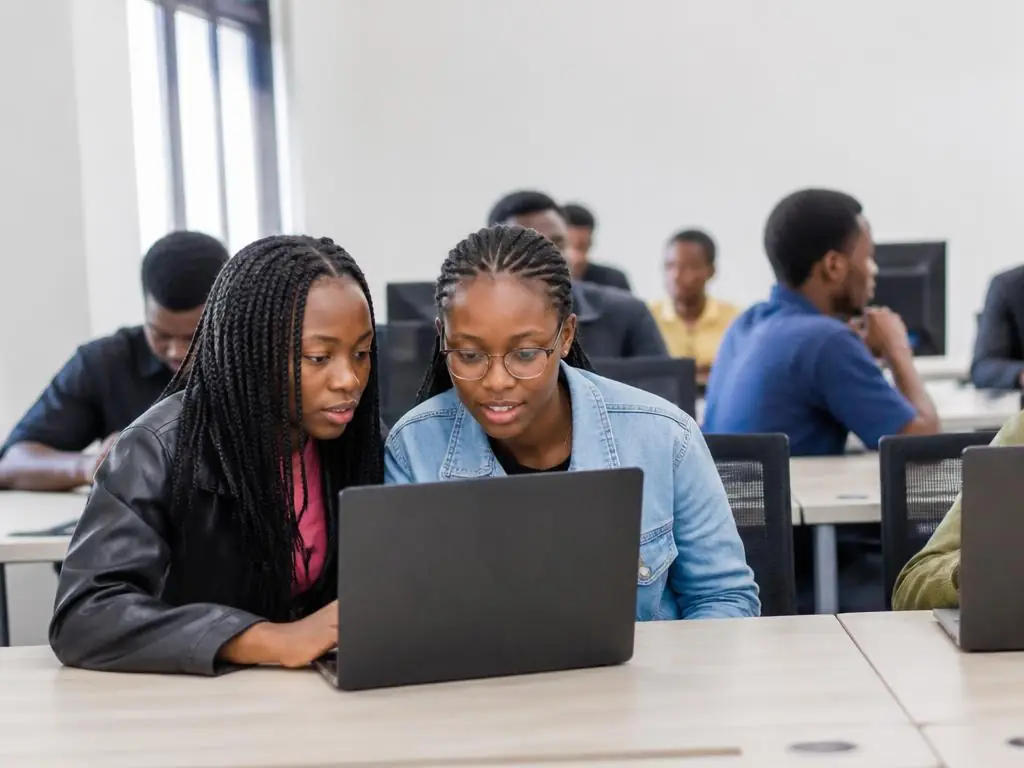 Young learners working on laptops in a StackForgeNext computer lab